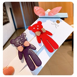 Three-piece set of knitted kids hair clips featuring a pink bow and two cute bears