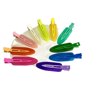 Set of 10 matte colorful non-marking hair clips arranged in a creative radial circle