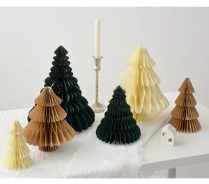 Detailed view of honeycomb paper Christmas tree ornaments in green cream and brown
