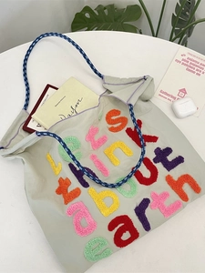 Minimalist canvas tote bag with colorful letter embroidery and woven rope handles