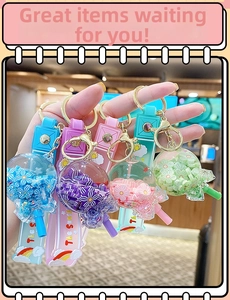 Detail of four colorful flower quicksand bottle keychains with silicone lanyards