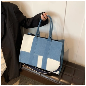 Blue and white patchwork canvas tote bag with reinforced straps and detachable shoulder belt