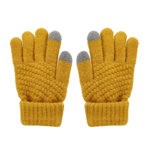 Detail of ginger yellow knitted winter gloves featuring grey touchscreen-friendly fingertips