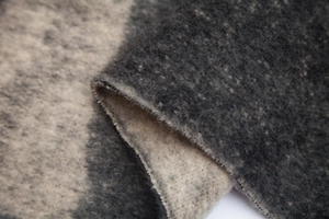 Macro shot of fluffy geometric mohair yarn fabric showing soft grey gradient texture