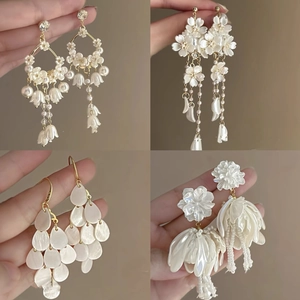 Elegant floral bow earrings with pearls and metallic tassels in cream white and gold