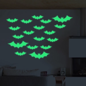 Luminous green bat wall stickers for Halloween glowing in a dark room setting