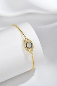 Detailed shot of gold Evil Eye bracelet featuring blue and white pavé cubic zirconia