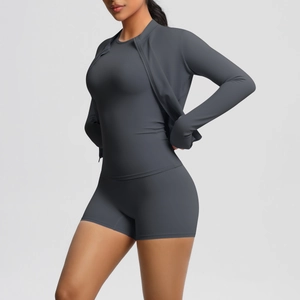 Detail of three-piece charcoal grey yoga set showing zipper jacket and fitted shorts