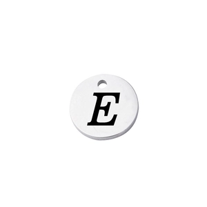 Macro shot of mirror-polished stainless steel round pendant featuring a black letter E