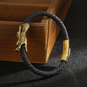 Men's black braided leather bracelet with golden dragon head clasp in premium studio setting