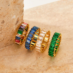 Regenbogen-Zirkonia-Ringe aus vergoldetem Edelstahl auf einem Naturstein Hintergrund
