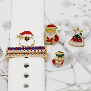 Detail of Christmas style watch band charms with Santa Claus and tree on white silicone strap