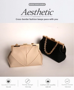 Close-up of elegant V-pattern evening bags with metallic frames and chunky gold chains