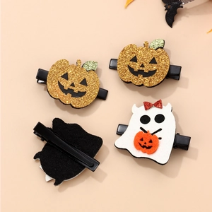 Detail view of Halloween glitter pumpkin and felt ghost hair clips with metal alligator grip