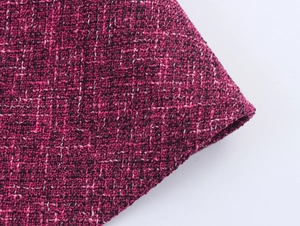 Detailed macro view of the purple and black textured tweed fabric weave and material texture