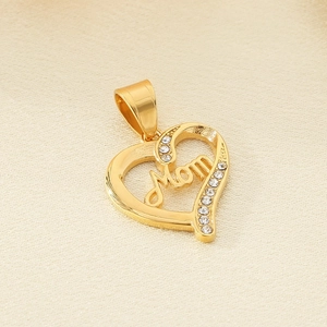 Macro detail of gold-plated Mom heart pendant with sparkling cubic zirconia on silk