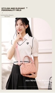 Detail of pink quilted crossbody bag featuring gold metal logo and adjustable strap