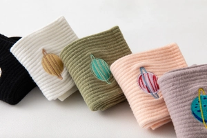 Detail of five-color ribbed cotton crew socks featuring delicate planet embroidery