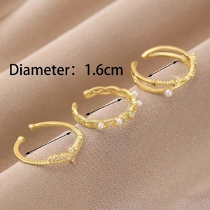 Detail showing 1.6cm diameter measurement of gold rings with pearls and rhinestones