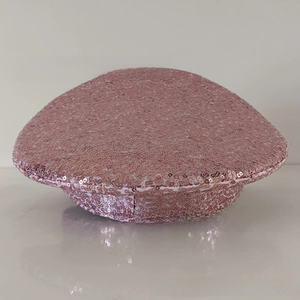 Detailed view of pink sequined military style hat with high-density metallic finish