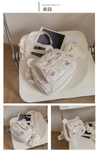 Detail of cream white canvas crossbody bag with cute bear ears and plush charm