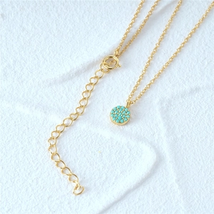 Detail of S925 silver sunflower necklace with turquoise inlay and gold finish