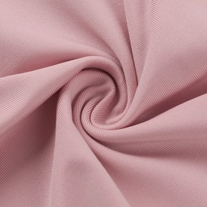 Close-up of pink ribbed knit fabric with soft spiral pleats and smooth texture detail