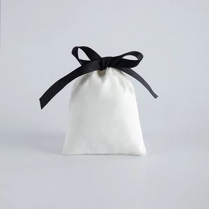 White velvet jewelry drawstring bag with black ribbon bow for gift packaging