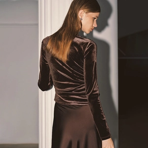Détail du haut en velours marron foncé avec coupe élégante au dos et texture soyeuse