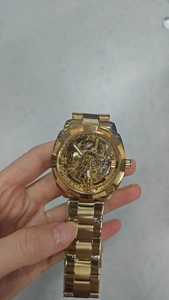 Macro shot of gold automatic mechanical watch dial with hollow skeleton gear movement