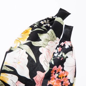 Bohemian floral fabric headband with colorful flower patterns on a black base