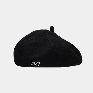 Close-up of the 1987 embroidery detail on a black wool blend beret hat for women