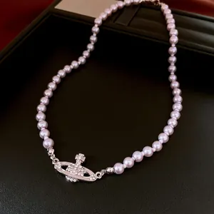 Exquisite lavender pearl necklace with a shimmering rhinestone studded saturn orb pendant