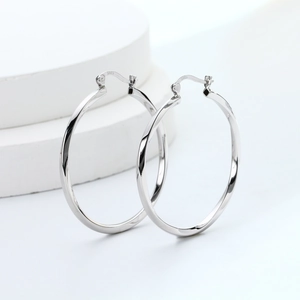 Detail shot of hollow S925 sterling silver hoop earrings with twisted texture finish