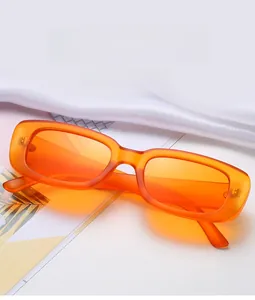 Detail of retro orange translucent rectangle sunglasses with matte resin frames