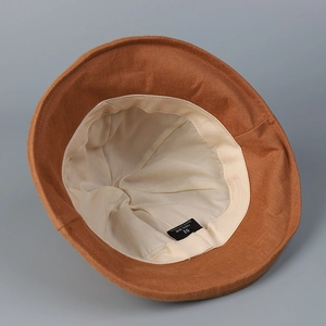 Premium brown linen bucket hat for women showing beige lining and interior detail