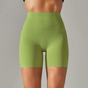 Detail view of high-waist green yoga shorts with flatlock seams and matte texture