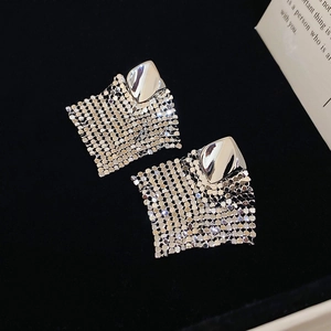Detailed shot of silver diamond-shaped sequins and fine metal mesh tassels on a jewelry box