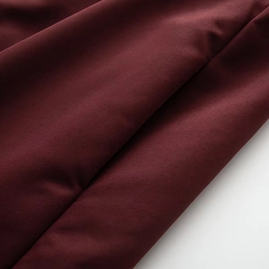 Macro shot of burgundy plain weave fabric with subtle luster and elegant drape