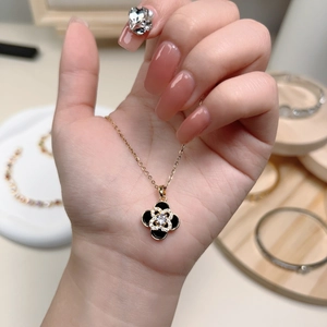 Elegant gold titanium steel four-leaf clover necklace with black enamel and crystals