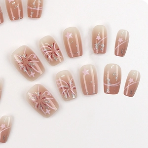 Pink gradient press-on nails with star patterns, fireworks and sparkling silver glitter