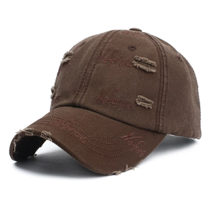Close-up of distressed baseball cap featuring vintage wash canvas and embroidery detail