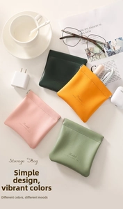 Flat lay of colorful leather pouches showing squeeze top closure for digital accessories