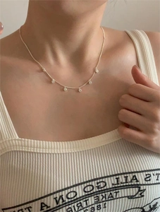 Detailed view of silver rope chain necklace with six sparkling zircon circle charms