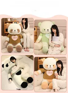 Detail view of large panda plush toys in various colored sweaters on a cozy sofa