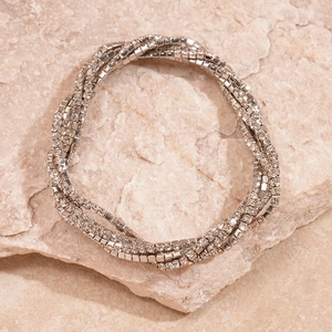 Detail of silver multi-layer rhinestone bracelet on natural stone background