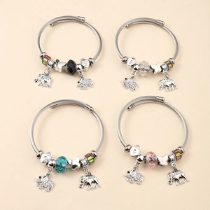 Close-up of elephant charm bracelet set with faceted beads and silver steel mesh bands
