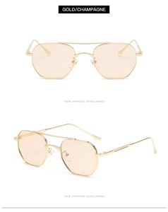 Detail view of double bridge sunglasses with champagne gold frames and light gradient lenses