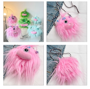 Detail view of plush monster crossbody bag with long braids in pink, green, and blue