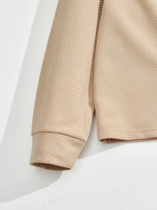 Detailed close-up showing the premium twill texture and stitching on the beige jacket cuff